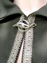 Green hooded cloak with braided trim